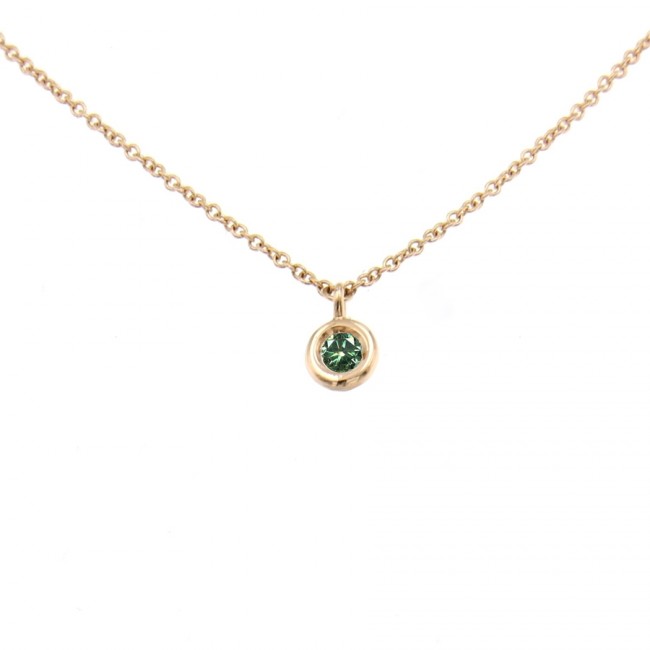 Gold charm with green diamond